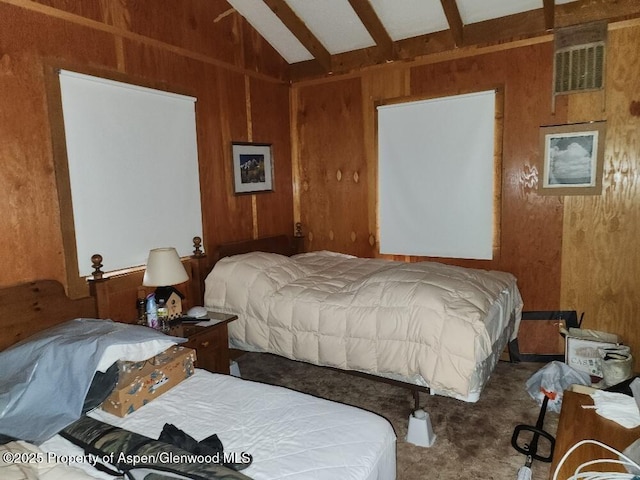 bedroom featuring visible vents, carpet flooring, wooden walls, and vaulted ceiling