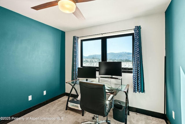 carpeted home office with ceiling fan