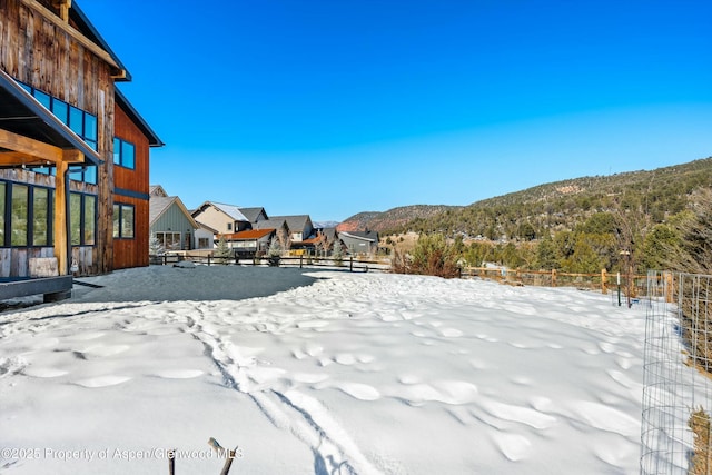 yard covered in snow with a mountain view