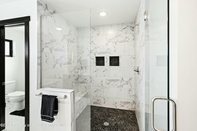 bathroom featuring walk in shower and toilet