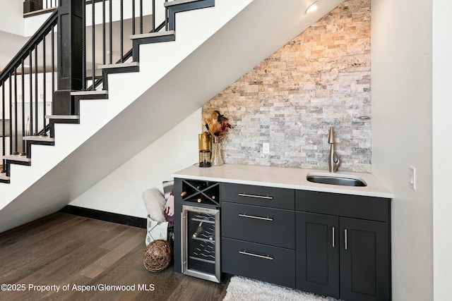 bar featuring sink, wine cooler, and dark hardwood / wood-style flooring