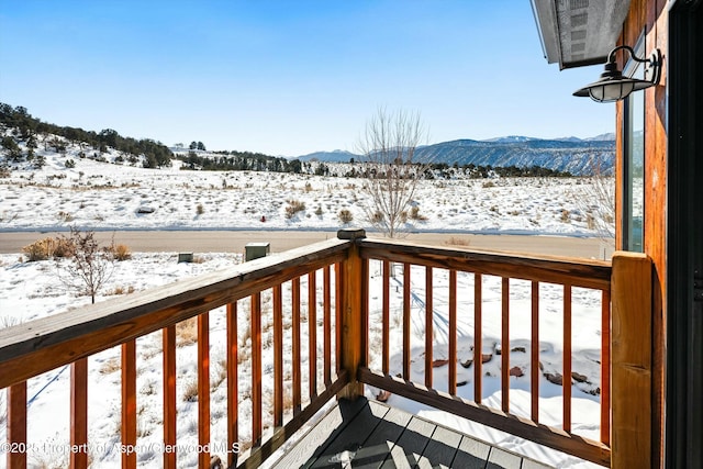 snow covered deck featuring a mountain view