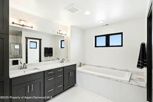 bathroom with vanity and independent shower and bath