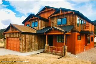 cabin with a garage and covered porch