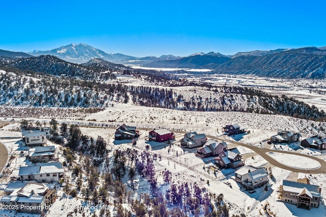 snowy aerial view with a mountain view