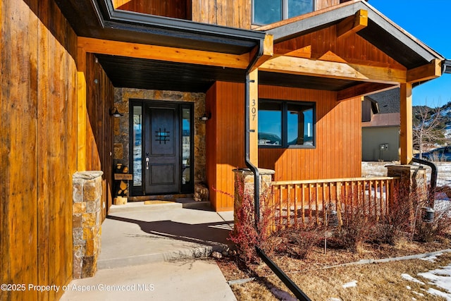 view of exterior entry featuring a porch