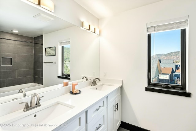 bathroom featuring vanity, a mountain view, and tiled shower / bath