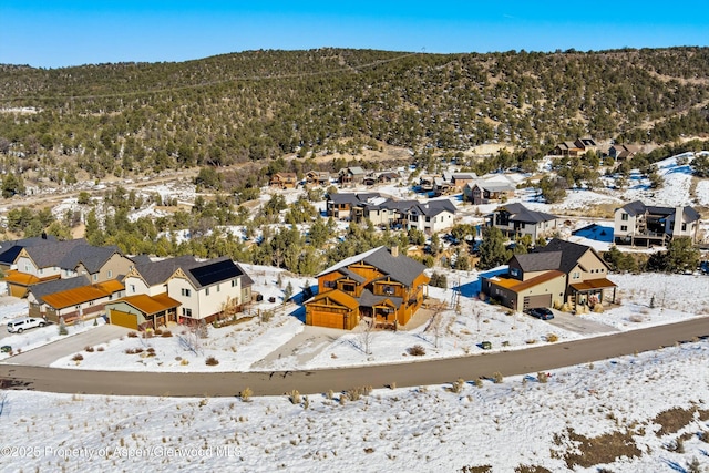 snowy aerial view featuring a mountain view