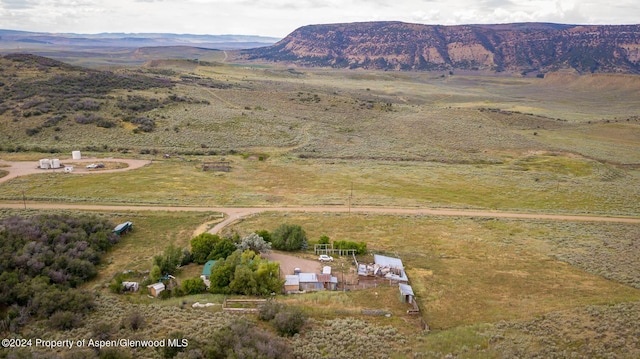 birds eye view of property with a mountain view and a rural view
