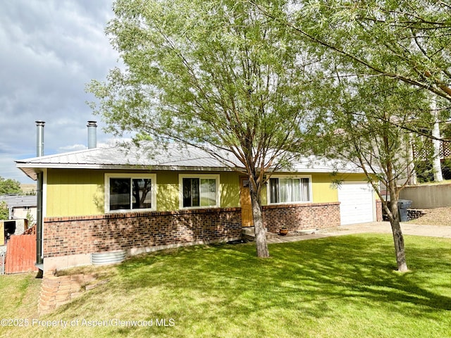 1111 Barclay St, Craig, CO 81625 - view of front facade with brick siding, concrete driveway, a garage, and a front lawn