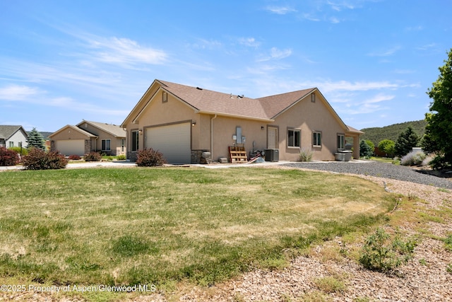 325 SE Cobblestone Ct, Cedaredge, CO 81413 - view of property exterior with stucco siding, a garage, a yard, and concrete driveway