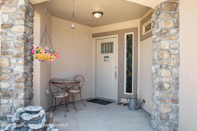 325 SE Cobblestone Ct, Cedaredge, CO 81413 - property entrance featuring stone siding and stucco siding