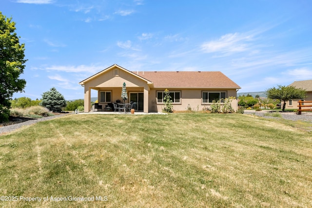 325 SE Cobblestone Ct, Cedaredge, CO 81413 - rear view of house featuring a patio area, stucco siding, and a yard