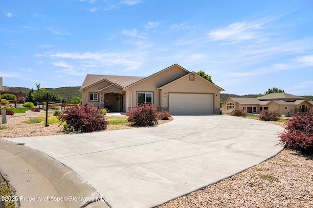 325 SE Cobblestone Ct, Cedaredge, CO 81413 - single story home featuring stone siding, an attached garage, stucco siding, and driveway