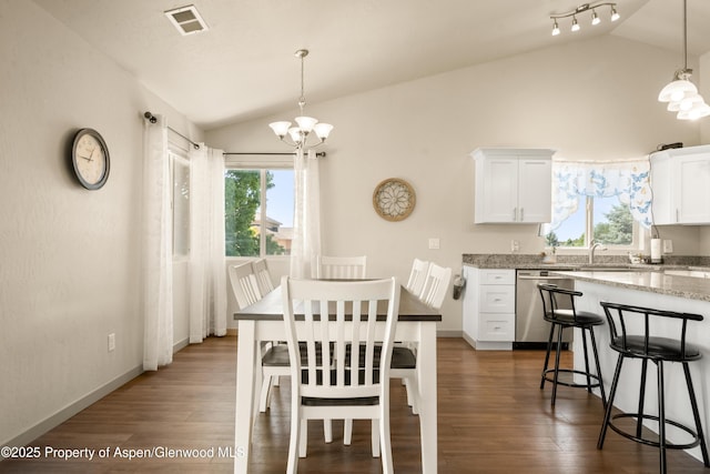 325 SE Cobblestone Ct, Cedaredge, CO 81413 - dining area with lofted ceiling, a chandelier, and dark wood-style floors