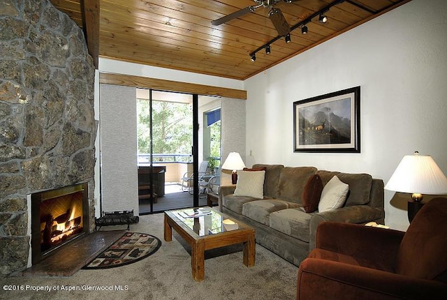 living room with rail lighting, carpet flooring, ceiling fan, a fireplace, and wood ceiling