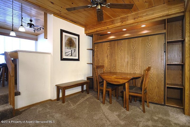 dining space with carpet flooring, ceiling fan, and wooden ceiling