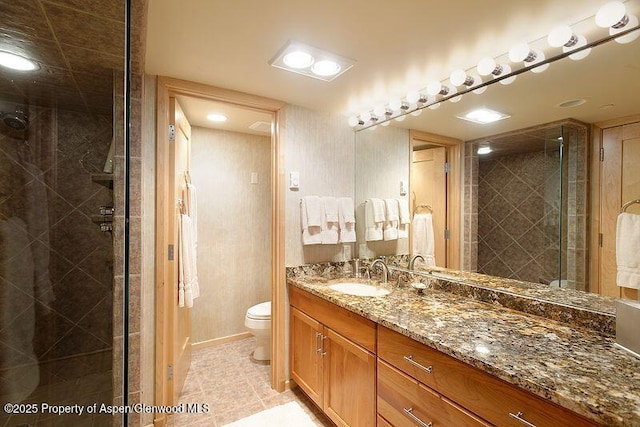 bathroom featuring vanity, toilet, walk in shower, and tile patterned floors