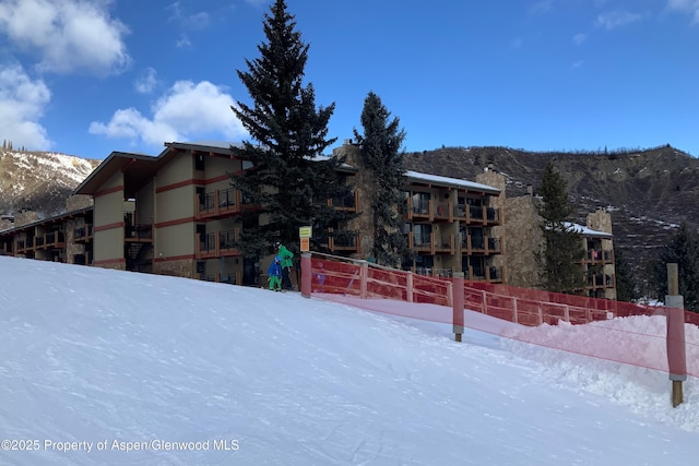 snow covered building with a mountain view