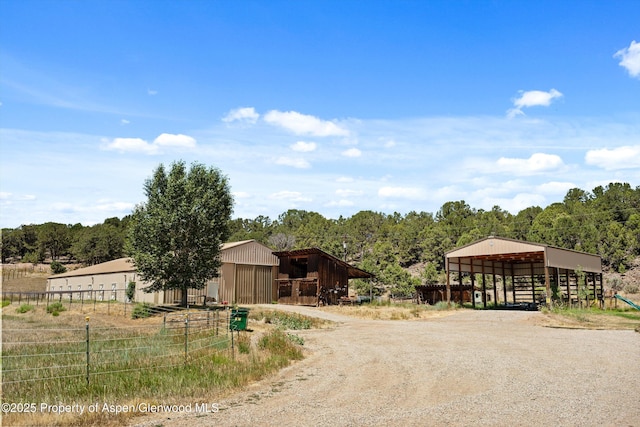 14 Fender Ln, Carbondale, CO 81623 - view of dirt / gravel road featuring a pole building and a wooded view