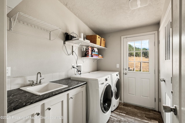 14 Fender Ln, Carbondale, CO 81623 - laundry area with independent washer and dryer, cabinet space, dark wood-type flooring, and a textured ceiling