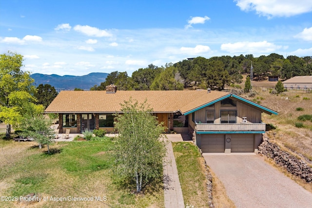 14 Fender Ln, Carbondale, CO 81623 - view of front of property featuring a garage, driveway, a chimney, and covered porch