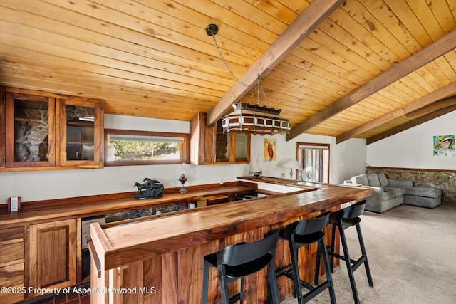 14 Fender Ln, Carbondale, CO 81623 - kitchen with wood counters, carpet floors, glass insert cabinets, wooden ceiling, and a kitchen bar