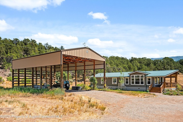 14 Fender Ln, Carbondale, CO 81623 - view of pole building with dirt driveway, a detached carport, and a forest view
