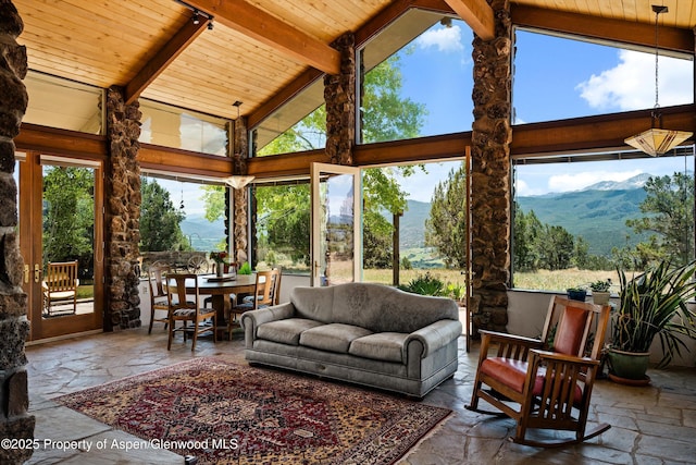 14 Fender Ln, Carbondale, CO 81623 - sunroom featuring a mountain view, high vaulted ceiling, stone tile flooring, and a wood ceiling with exposed beams