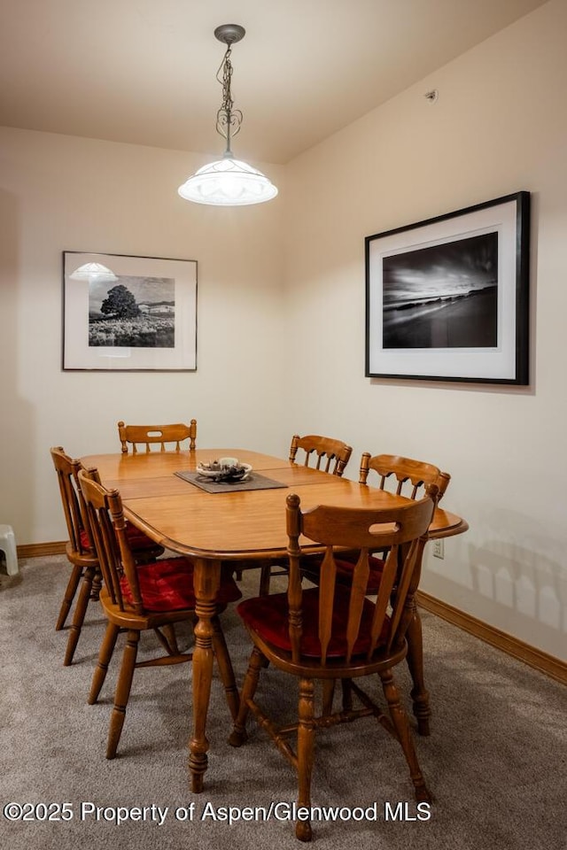 dining area with carpet flooring and baseboards