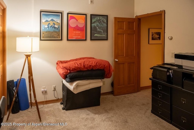 sitting room with baseboards and carpet flooring