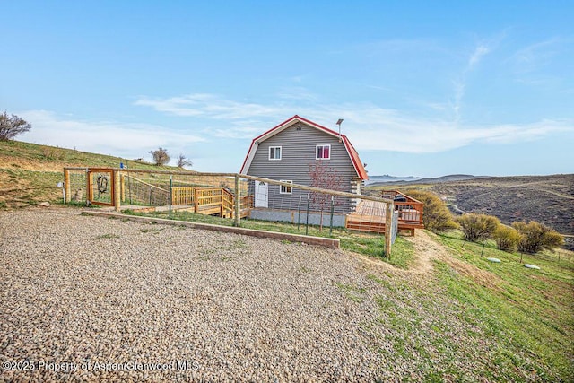 950 Highland Dr, Craig, CO 81625 - view of front of property featuring a gambrel roof and a wooden deck