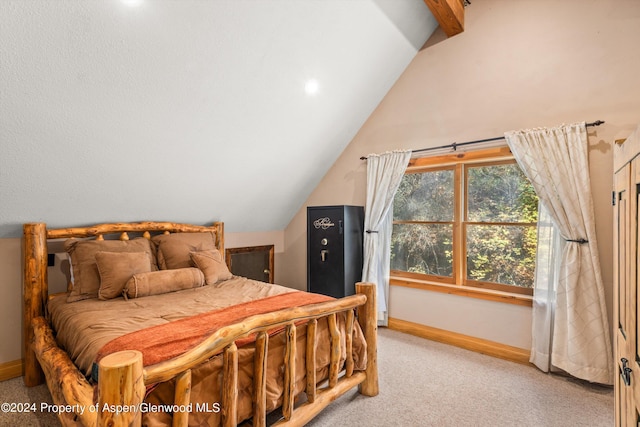 carpeted bedroom featuring lofted ceiling with beams