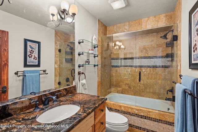 full bathroom with vanity, a chandelier, combined bath / shower with glass door, and toilet