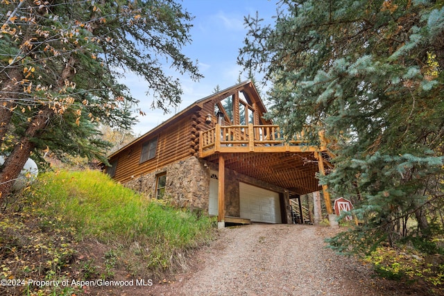 view of home's exterior featuring a deck and a garage