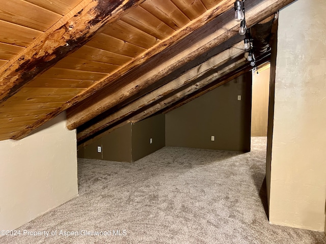 additional living space with carpet flooring, lofted ceiling with beams, and wooden ceiling