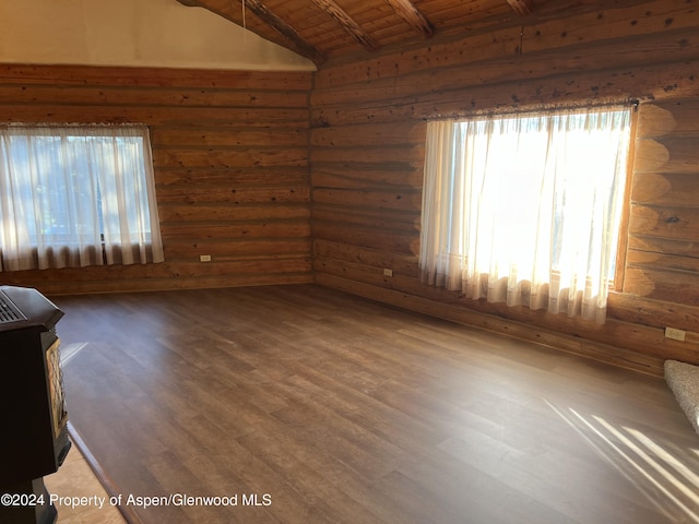 spare room with vaulted ceiling with beams, wood-type flooring, wood ceiling, and log walls