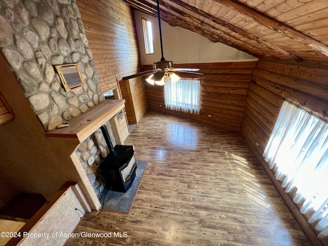 unfurnished living room featuring wooden ceiling, lofted ceiling with beams, wooden walls, hardwood / wood-style flooring, and ceiling fan