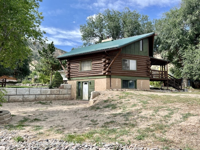 back of house featuring a deck