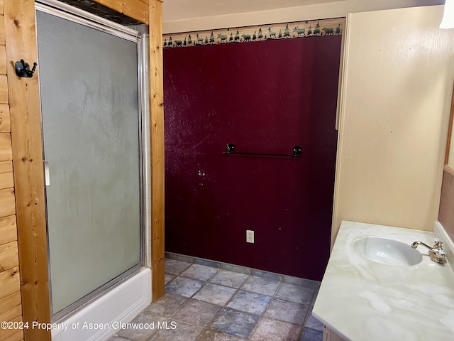 bathroom with vanity and enclosed tub / shower combo