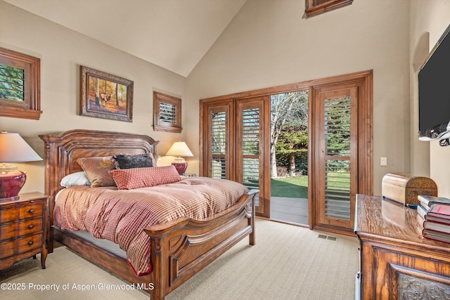 bedroom with access to outside, high vaulted ceiling, and visible vents