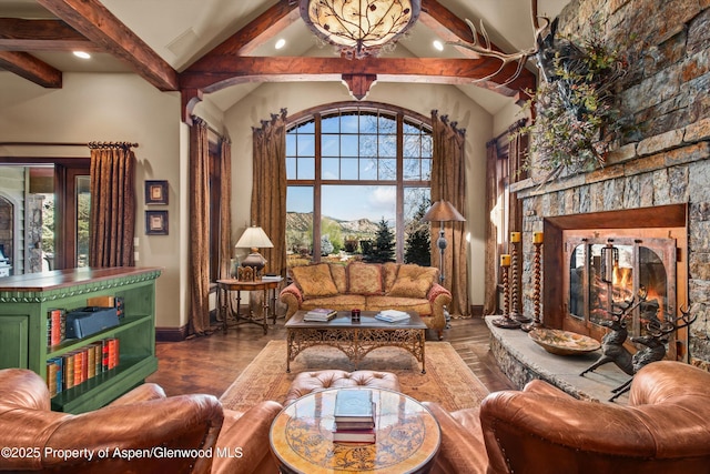 sitting room with a stone fireplace, recessed lighting, baseboards, wood finished floors, and beamed ceiling