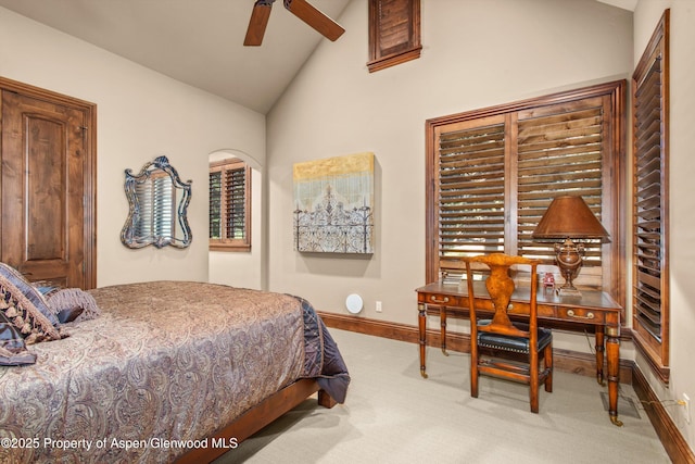 bedroom with high vaulted ceiling, light colored carpet, and baseboards