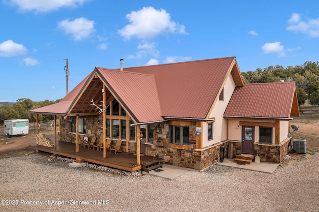 76 County Road 60b, Maybell, CO 81640 - rear view of house featuring stone siding, central AC unit, and metal roof