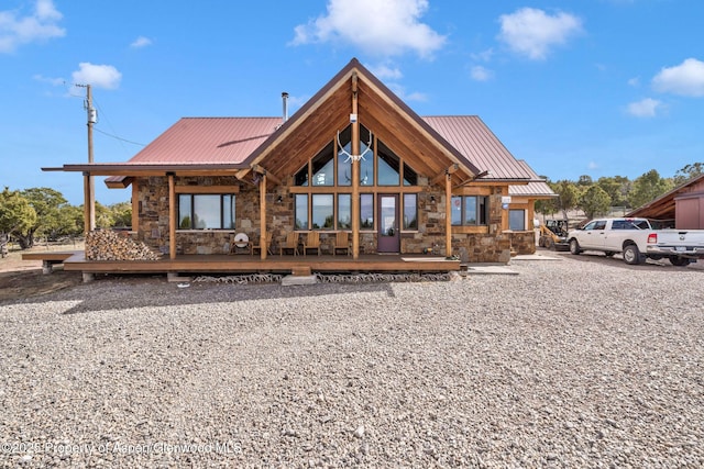 76 County Road 60b, Maybell, CO 81640 - rear view of property featuring stone siding, a standing seam roof, and metal roof