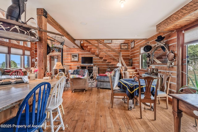 76 County Road 60b, Maybell, CO 81640 - dining room with beamed ceiling, wooden walls, and hardwood / wood-style floors