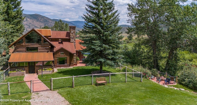 exterior space featuring a mountain view and a yard