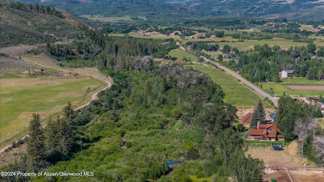 drone / aerial view with a mountain view and a rural view