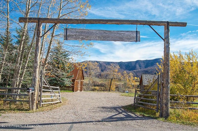 1150 Capitol Creek Rd, Snowmass, CO 81654 - view of dirt / gravel driveway with a mountain view and a gated entry