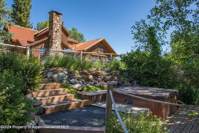 exterior space with a hot tub